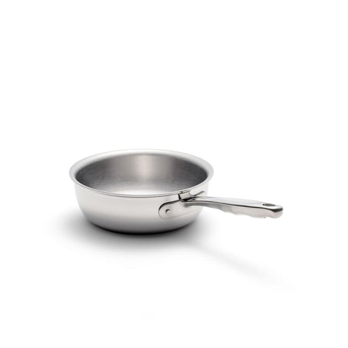 Three-quarter view of 2-quart stainless steel saucier showcasing flared sides and long riveted handle on white background