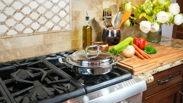 Stovetop with a pot, cutting board with vegetables, and kitchen decor.