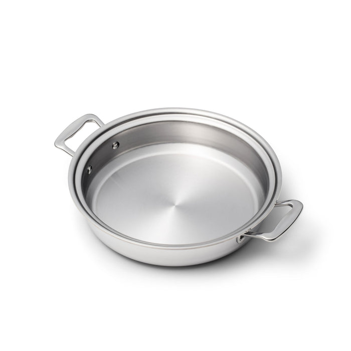 Angled top view of sauté pan showcasing polished stainless steel interior and two short side handles on white background