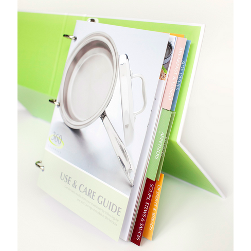 Angled view of 360 Cookbook binder showing ring binding, Use and Care Guide cover and colored tabs on white background