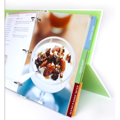 Angled view of 360 Cookbook binder showing an open recipe page with a yogurt parfait and colored section tabs on a white background