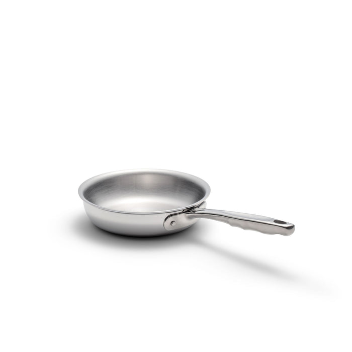 Stainless-steel frying pan with long handle and shadow on white background.