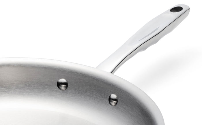 Close-up angled view of 7 Inch Fry Pan showing riveted long handle and brushed interior on white background