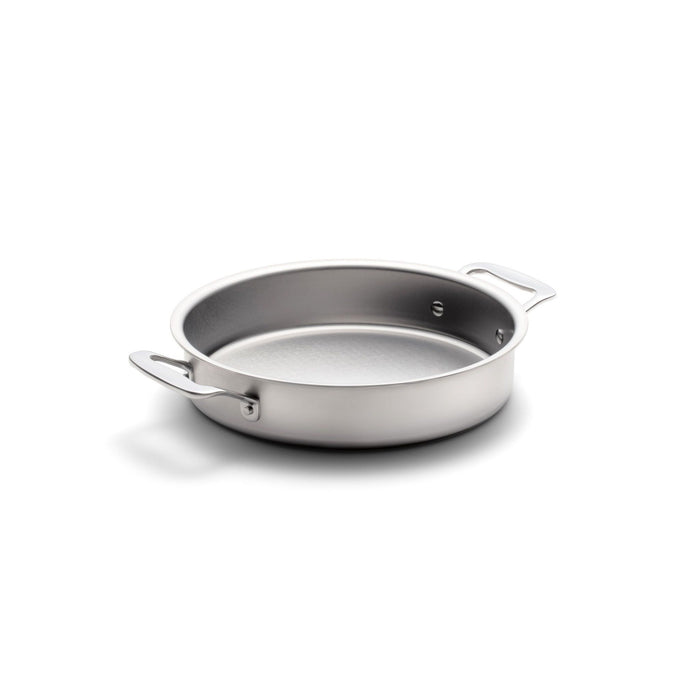 Angled view of 9 inch round cake pan with handles showcasing stainless steel construction on a white background
