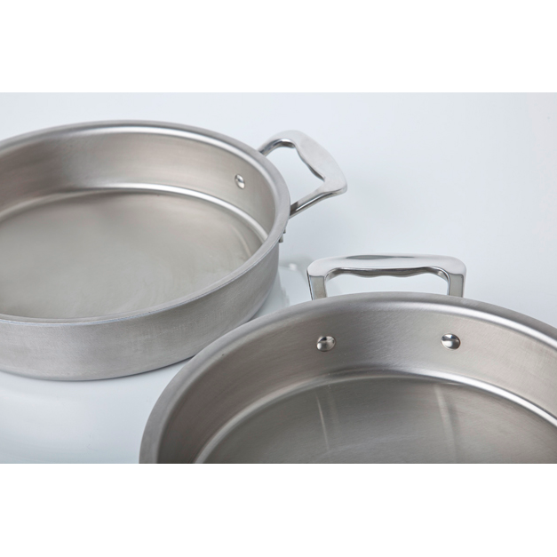 Top view of 9-inch round cake pan with handles showing brushed stainless-steel interior and riveted handles on light background