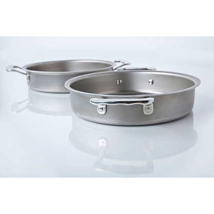 Angled front view of 9-inch round stainless steel cake pan with two handles showing brushed finish on a reflective white surface