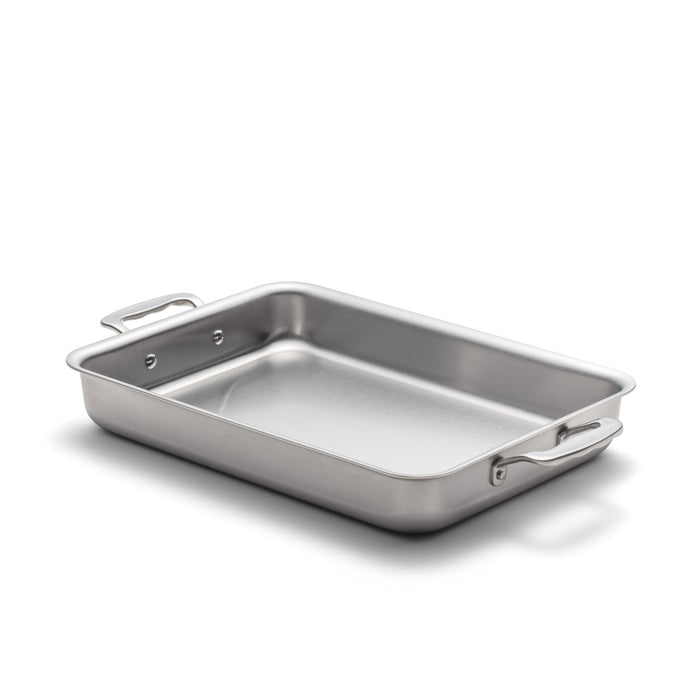 Angled view of 9 inch by 13 inch Bake and Roast Pan with Handles showcasing stainless steel on a white background