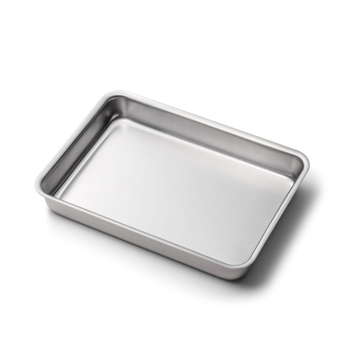 Angled view of 9 inch by 13 inch Bake and Roast Pan showcasing stainless steel construction with no handles on a white background