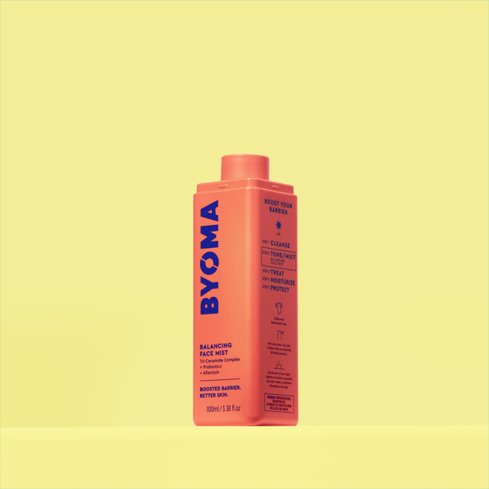 A BYOMA Balancing Face Mist in an orange bottle without a cap.