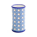 A cylindrical ceramic cup or candle holder with a blue and white geometric interlocking pattern, featuring a solid blue rim and base, set against a plain white background.