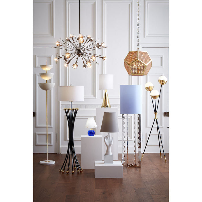 Collection of modern lamps and lighting fixtures in a room with white paneled walls.