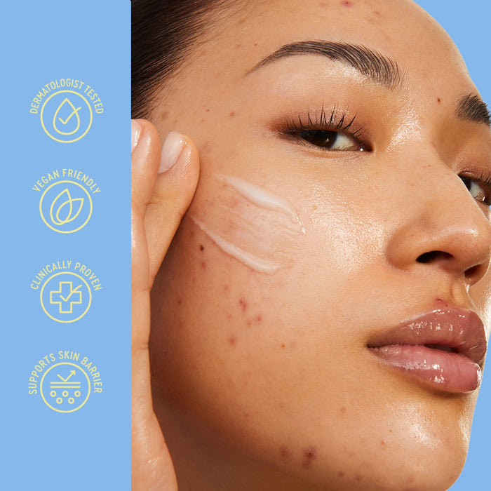 Close-up of a woman's face with a skincare cream swatch on her cheek, alongside vertical text badges reading 'DERMATOLOGIST TESTED', 'VEGAN FRIENDLY', 'CLINICALLY PROVEN', and 'SUPPORTS SKIN BARRIER'.
