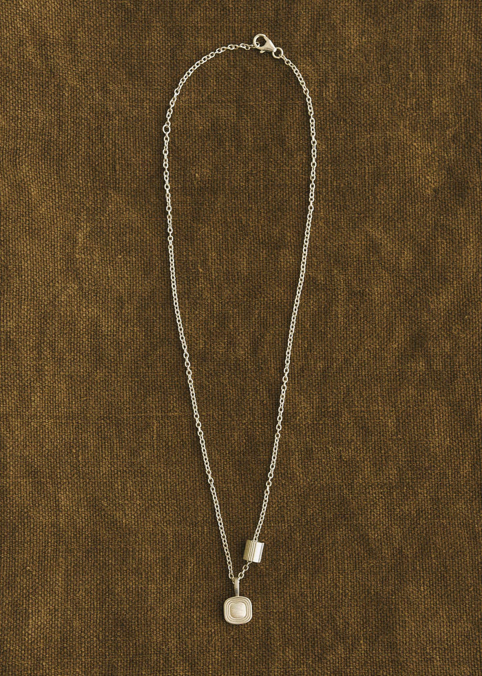 A Kinn x Shoppe Amber Interiors The Estate Pendant Necklace Sterling silver with an Estate Charm threaded onto the cable rolo chain