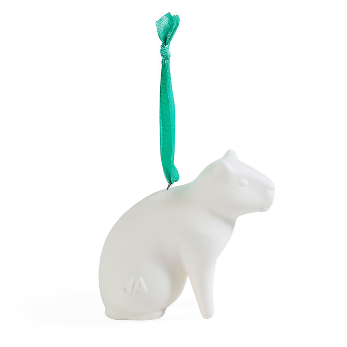 A white ceramic cat-shaped ornament with a small green ribbon loop at the top, shown on a clean white background.