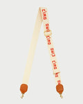 Cream-colored strap with red text and brown ends on a white background