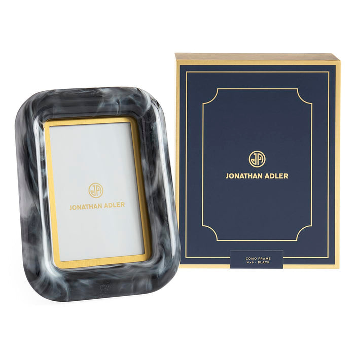 Marble-patterned photo frame with Jonathan Adler logo next to its packaging box on a white background
