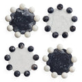Four round decorative coasters arranged in a 2x2 grid on a white background. Each coaster features a central marbled stone disc in black, white, or dark gray tones, surrounded by a ring of smooth spherical beads in white and dark gray.