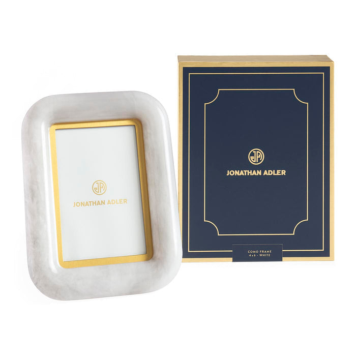 Marble photo frame with gold accents and Jonathan Adler packaging on a white background