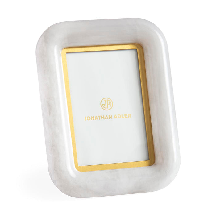 White rectangular jewelry dish with gold interior and 'Jonathan Adler' branding on a white background