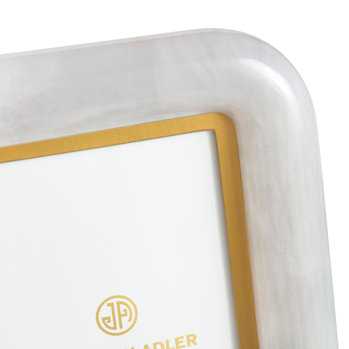 Close-up of a white electronic device with a gold border and logo on a white background