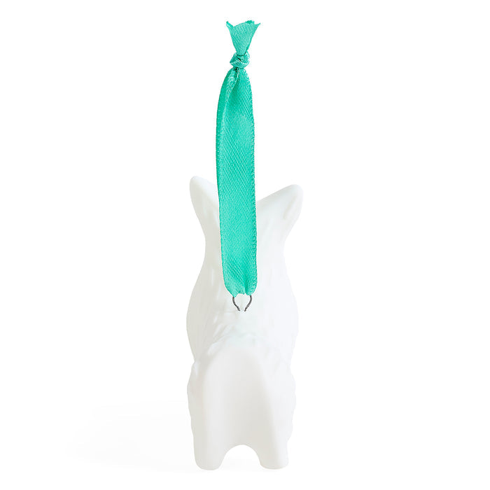 A white ceramic dog-shaped ornament with a bright turquoise green ribbon hanging from its neck, set against a plain white background.