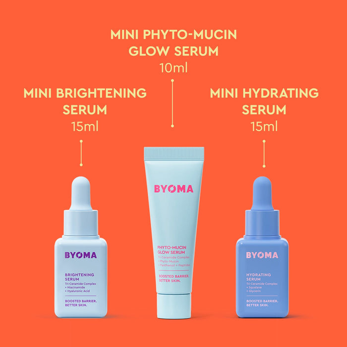 BYOMA Cosmic Glow Trio skincare products on an orange background.