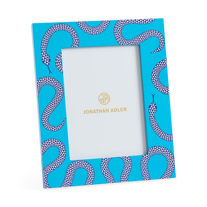 Notebook with snake pattern cover and white interior, Jonathan Adler branding visible