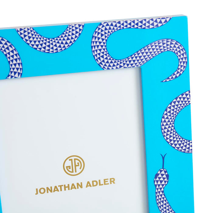Product packaging with snake pattern and 'Jonathan Adler' branding on a blue background