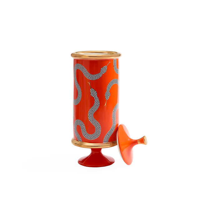 A red cylindrical decorative container with a matching lid leaning against it, featuring a white dotted snake pattern and gold-toned trim, photographed on a clean white background.