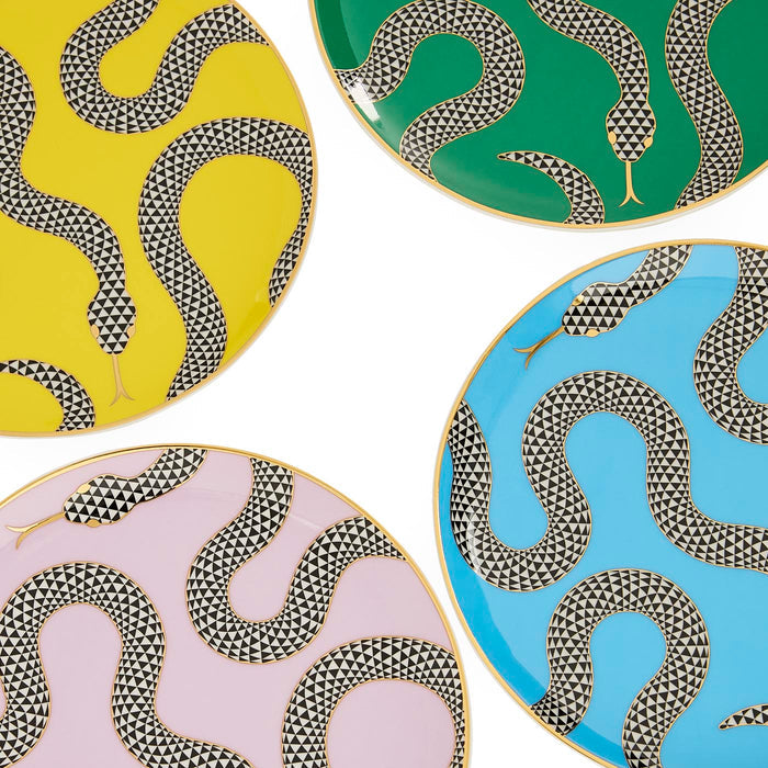 Four decorative plates with snake patterns on yellow, green, pink, and blue backgrounds.