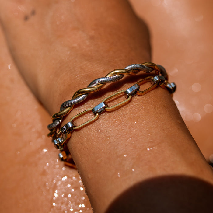 Mixed metal bracelet stack featuring two two tone bracelets