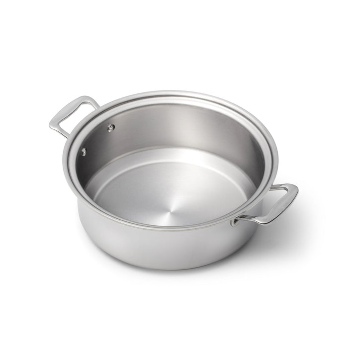 Angled top-down view of 6-quart stockpot (factory seconds) showing brushed stainless interior and two loop handles on white background