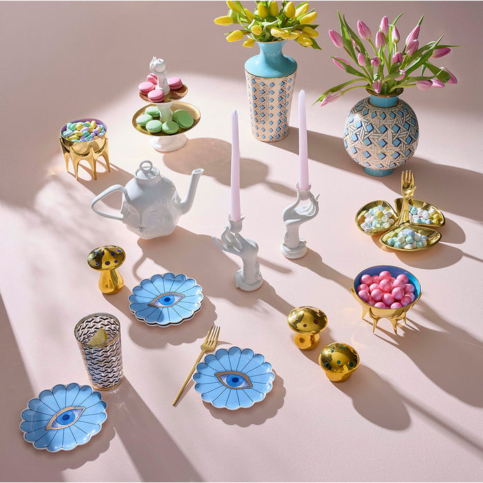 Collection of decorative items including vases, teapots, and small containers on a light pink background.