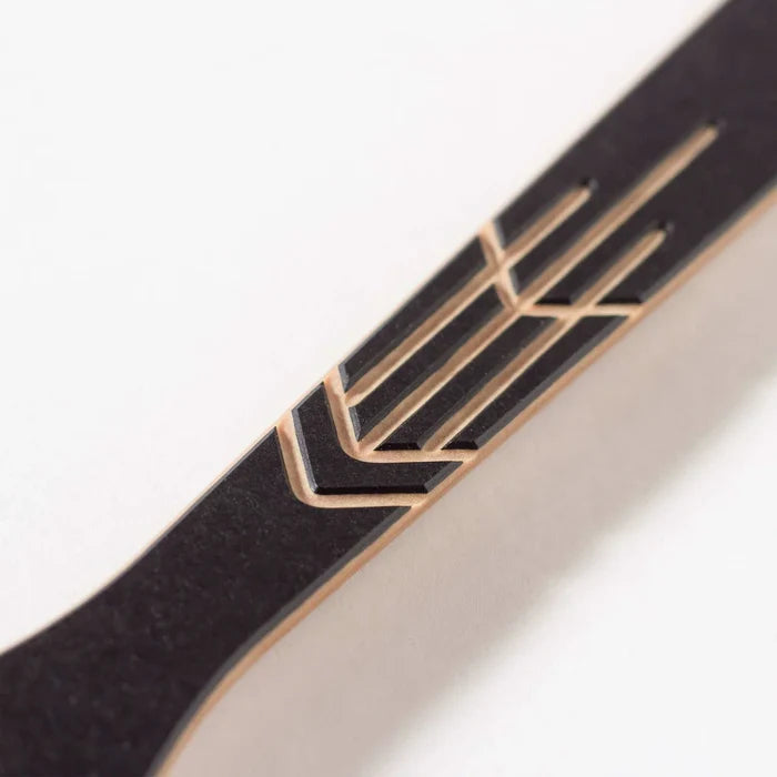 Close-up of Frank Lloyd Wright large spoon handle showcasing gold geometric inlay and light wood edge on white background