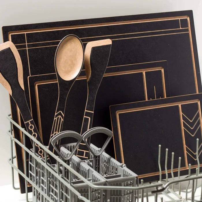 Angled view of Frank Lloyd Wright Large Spoon with black handle, gold geometric inlay, light wood bowl in dishwasher