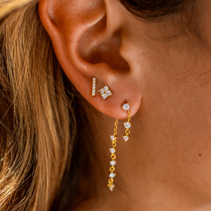 a gemstone diamond earring stack featuring a gemstone chain and two dainty gemstone studs