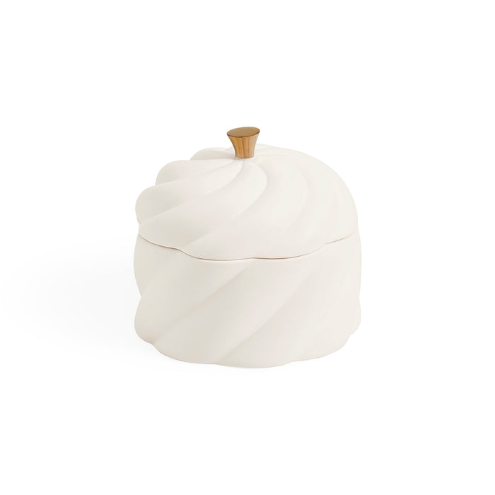 A white ceramic lidded container with a sculpted, ribbed surface and a small metallic gold knob on top, shown against a plain white background.