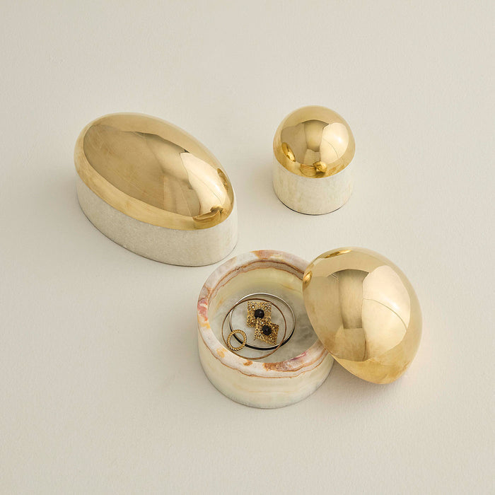 Set of gold and silver jewelry boxes on a light background