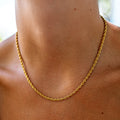 thin rope chain on a tan neck