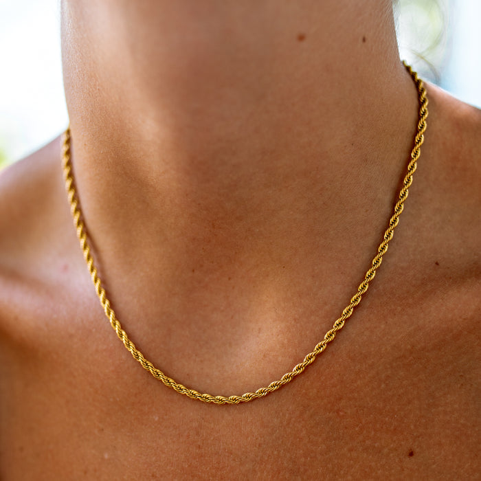 thin rope chain on a tan neck