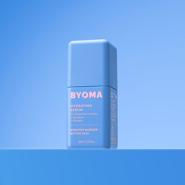 A light blue bottle of BYOMA Hydrating Serum centered on a matching blue gradient background.