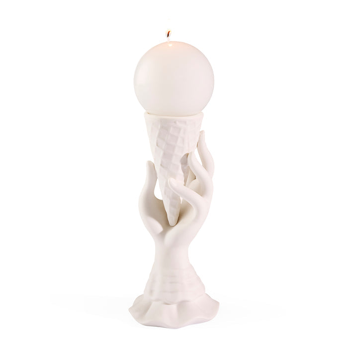 White candle holder with a spherical candle on a white background