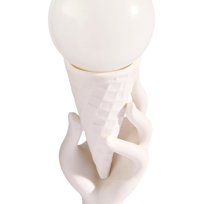 White ceramic sculpture of a hand holding a sphere on a white background