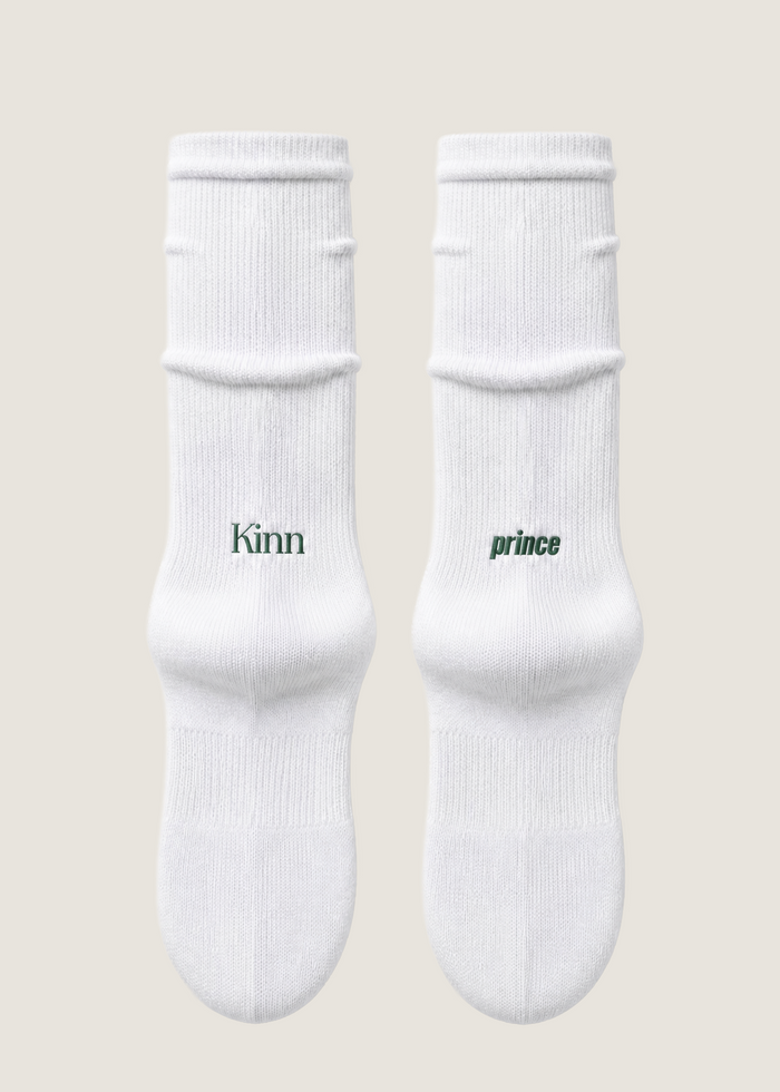 A pair of Kinn x Prince Crew Socks laying flat