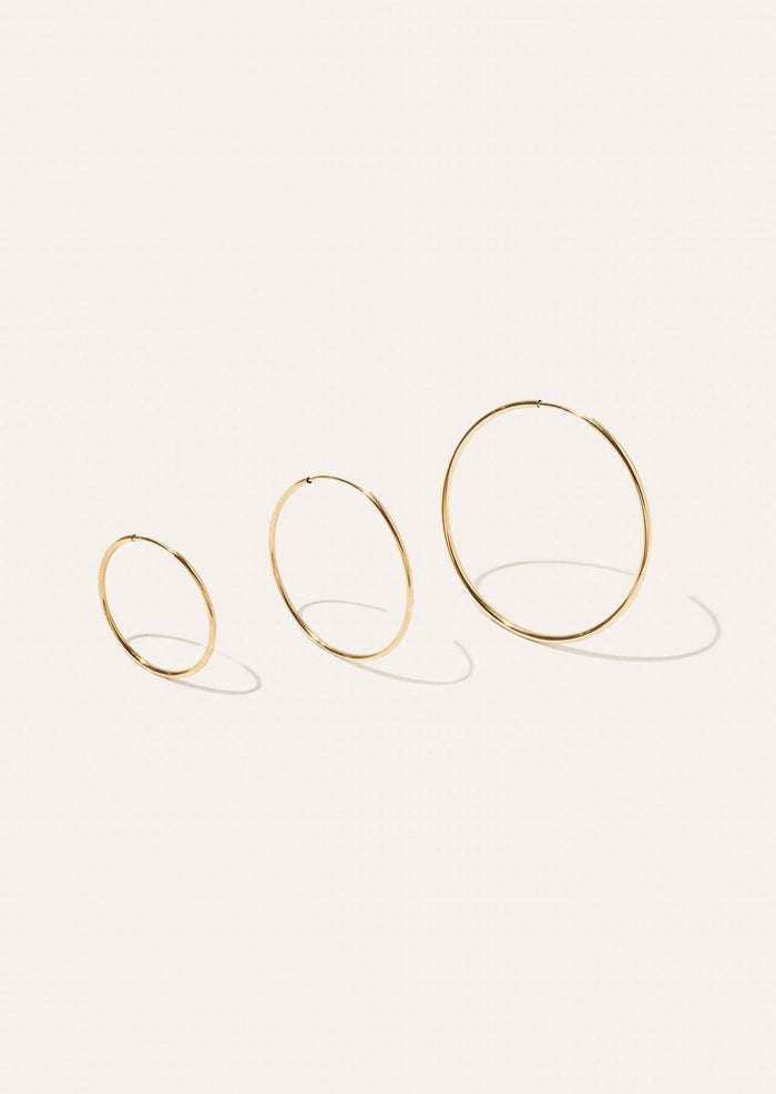 alt="Lightweight Hoop Earrings - Medium compared to the small and large"