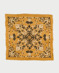 Mustard yellow bandana with black intricate patterns on a white background