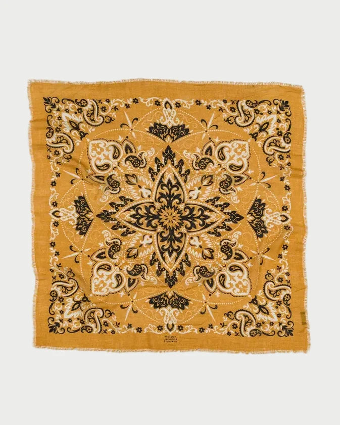 Mustard yellow bandana with black intricate patterns on a white background