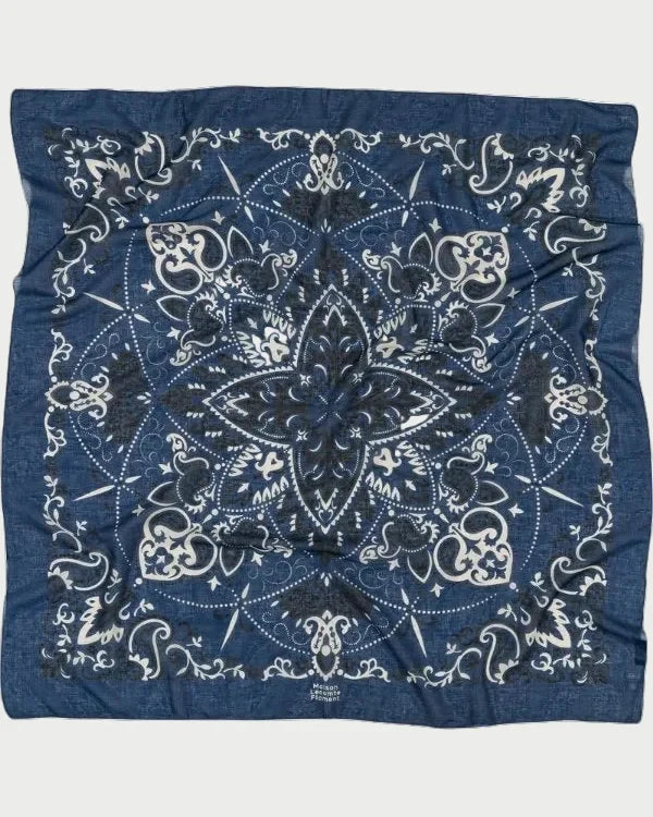 Blue bandana with white patterns on a white background