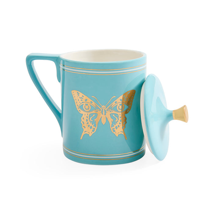 A light blue ceramic mug with a matching lid, decorated with a gold butterfly design and thin gold stripes, shown on a white background.