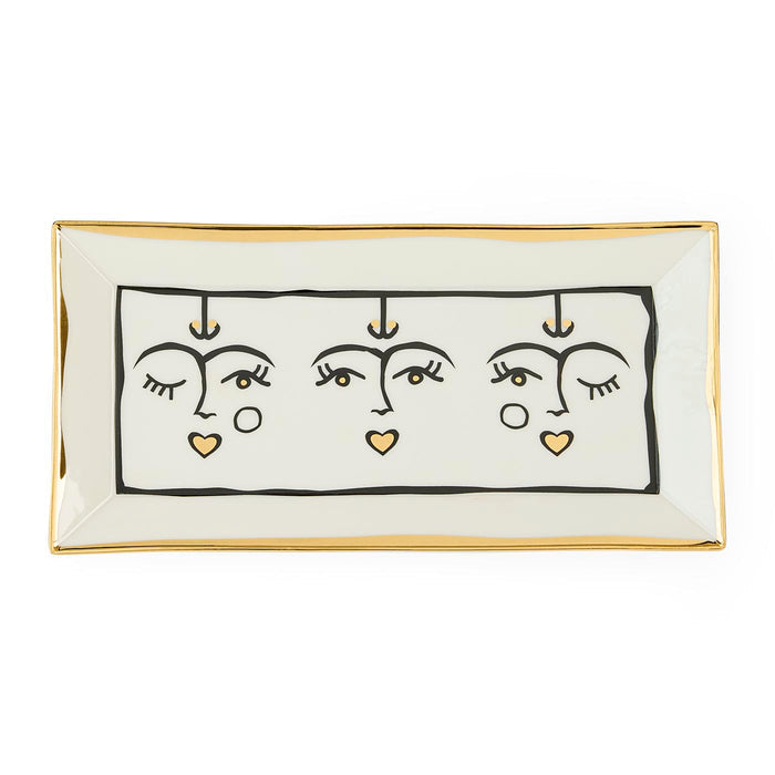 Rectangular ceramic tray with abstract face design on a white background